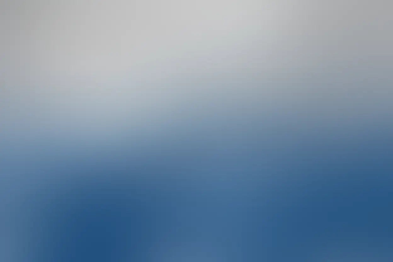 Gradient background transitioning from light gray to blue