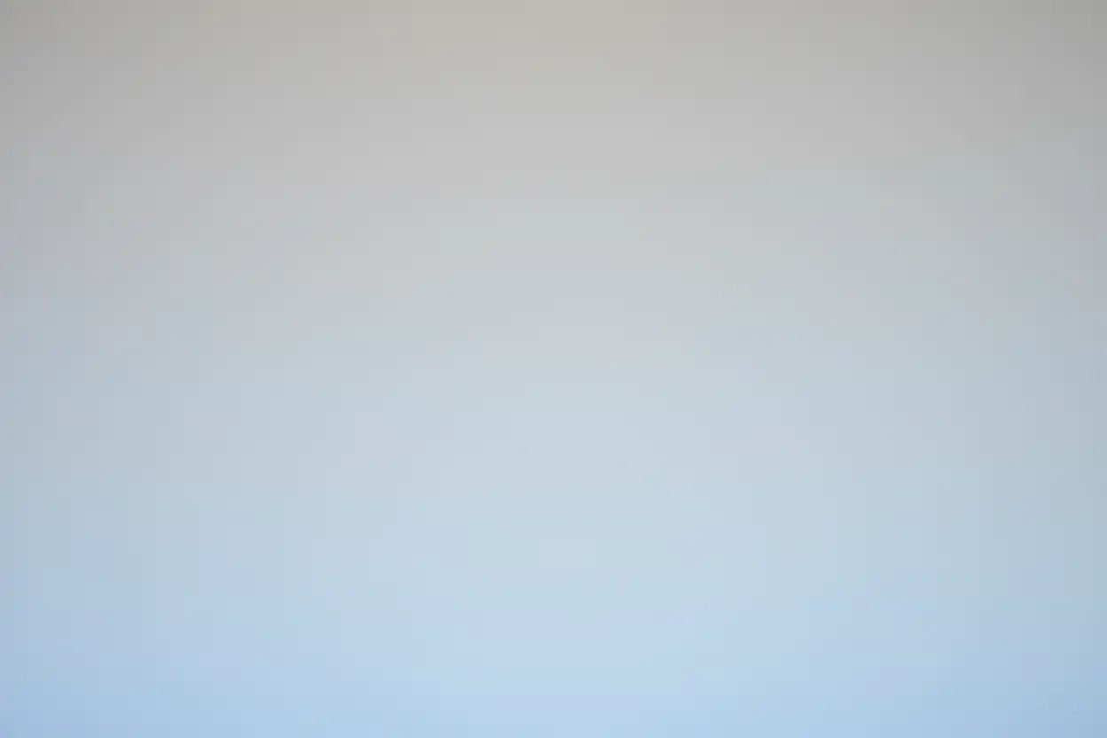 Gradient background transitioning from light gray to light blue